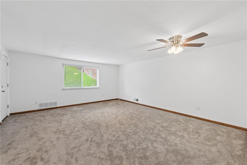 403 Homewood Avenue Trafford, PA 15085 - Photo 4 of 30 an empty room with a window and a fan
