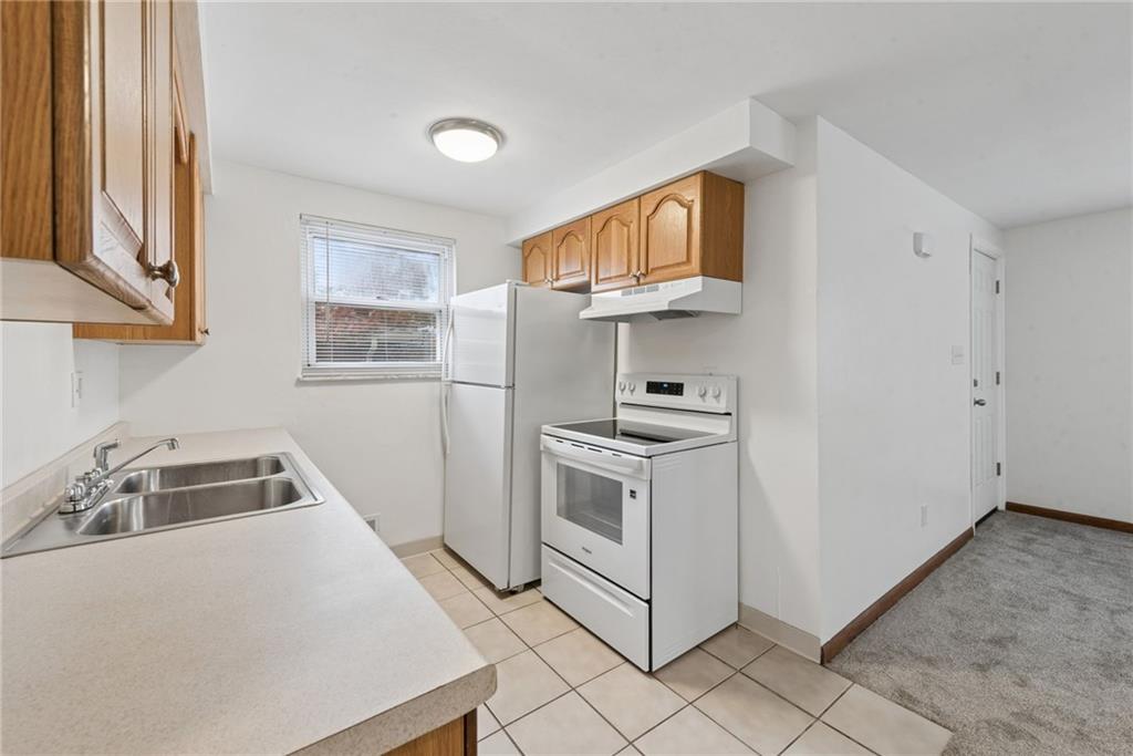 403 Homewood Avenue Trafford, PA 15085 - Photo 7 of 30 a kitchen with stainless steel appliances granite countertop a stove a sink and a refrigerator