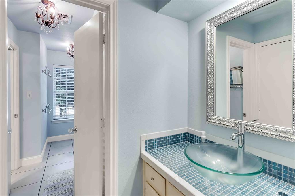 216 McMillen Road Lucas, TX 75002 - Photo 32 of 36 a bathroom with a granite countertop sink a mirror and shower