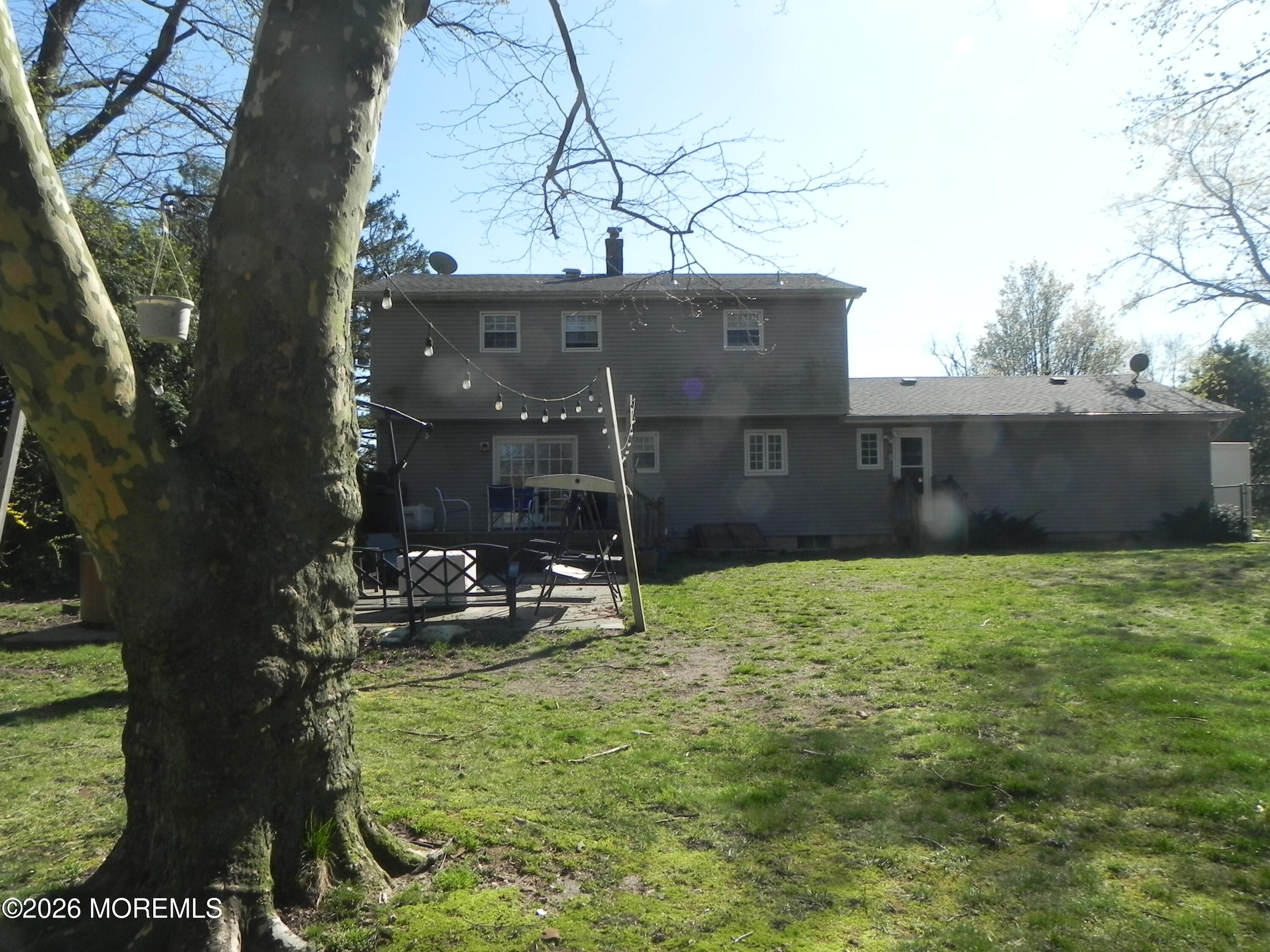 4 Westbrook Road Howell, NJ 07731 - Photo 18 of 18 a view of a backyard with table and chairs potted plants and large tree