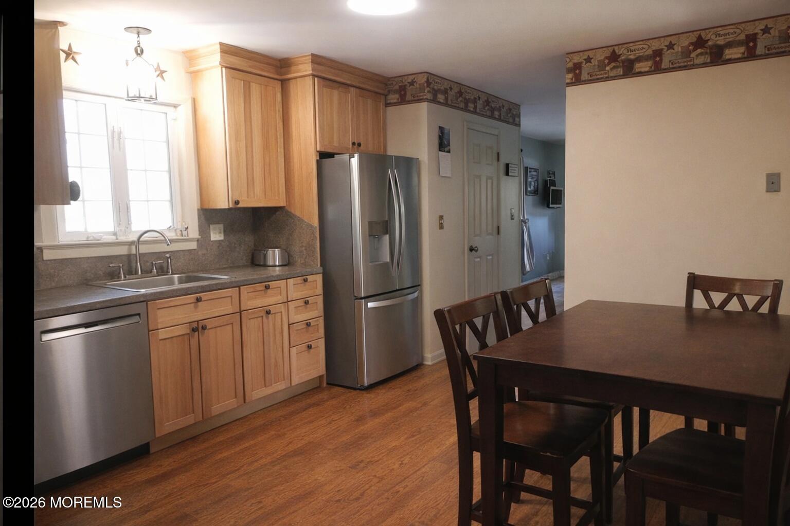 4 Westbrook Road Howell, NJ 07731 - Photo 6 of 18 a kitchen with stainless steel appliances a refrigerator a sink a stove a table and chairs