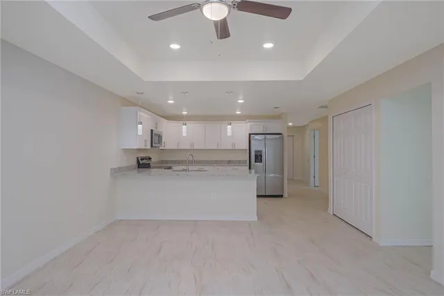 a view of kitchen and refrigerator