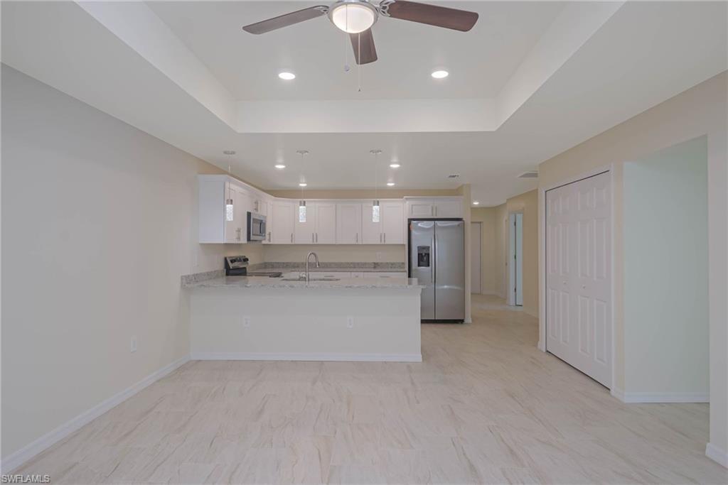 a view of kitchen and refrigerator