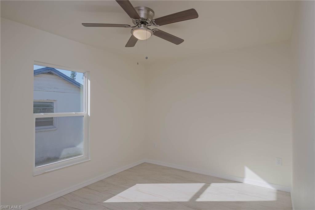 2120 French Street Fort Myers, FL 33916 - Photo 12 of 20 an empty room with a ceiling fan and a window