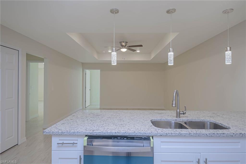 2120 French Street Fort Myers, FL 33916 - Photo 18 of 20 a kitchen with kitchen island a sink and chandelier