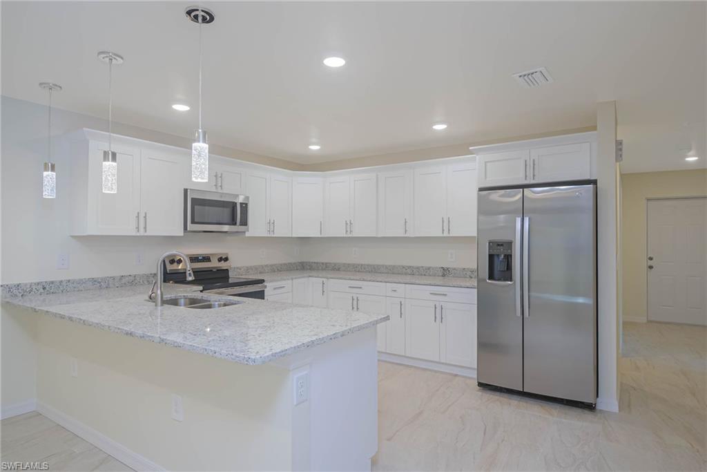 2120 French Street Fort Myers, FL 33916 - Photo 20 of 20 a kitchen with stainless steel appliances granite countertop a refrigerator a sink a stove a microwave and island