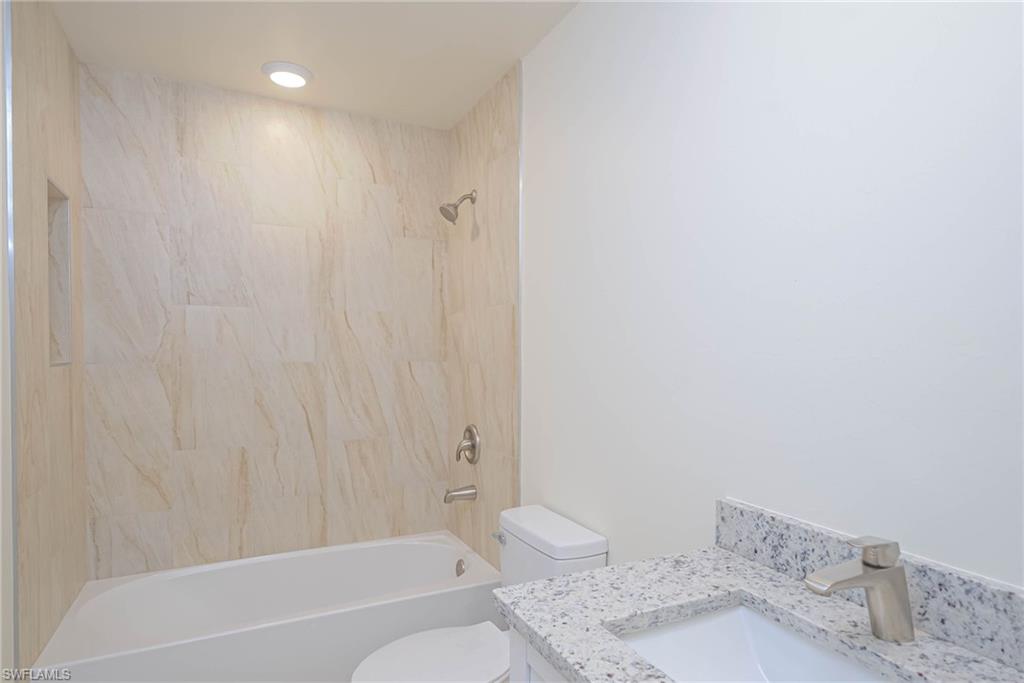 2120 French Street Fort Myers, FL 33916 - Photo 7 of 20 a bathroom with a granite countertop sink a toilet and bathtub