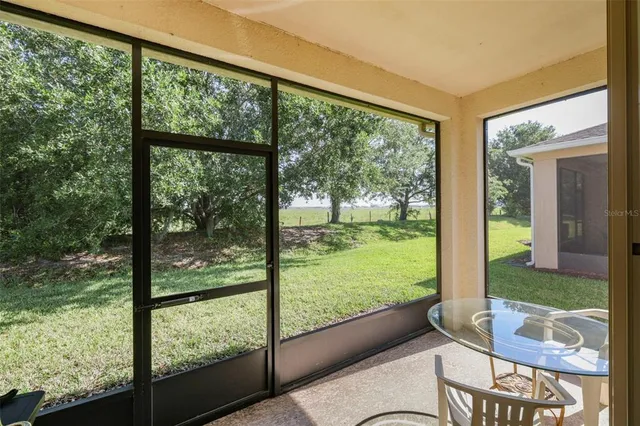 a living room with hardwood floor and balcony