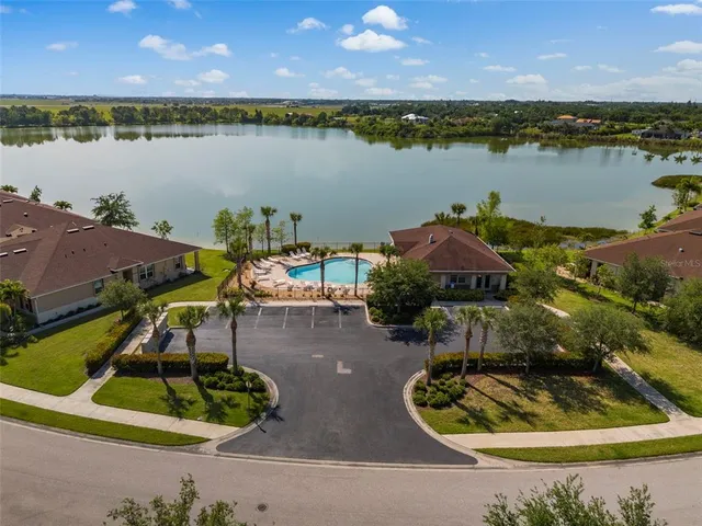 an aerial view of a house with outdoor space and lake view
