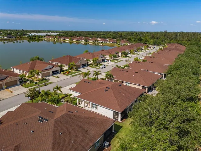 an aerial view of a houses with a lake view