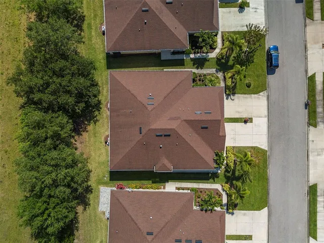 an aerial view of a house with a yard