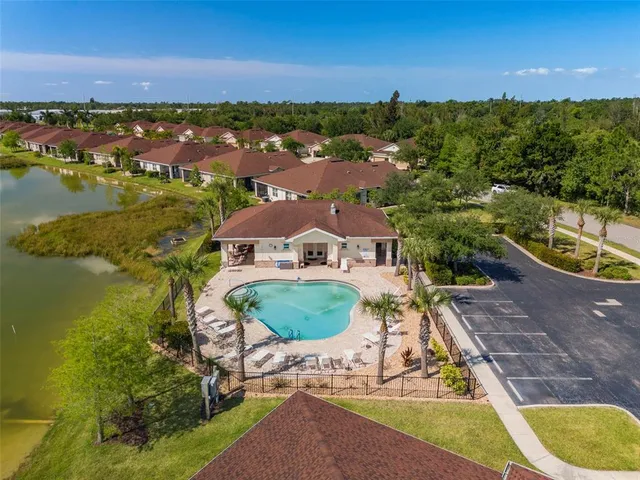 an aerial view of residential houses with outdoor space and lake view
