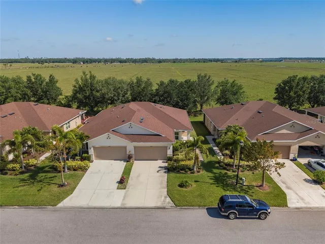 an aerial view of a house with outdoor space and ocean view