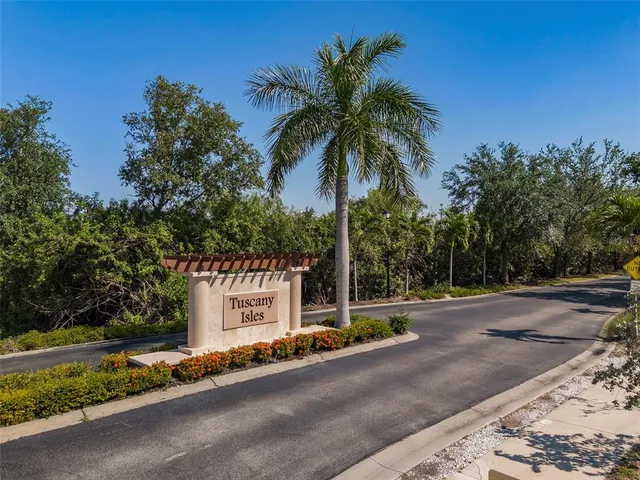 a view of a house with a yard and palm trees