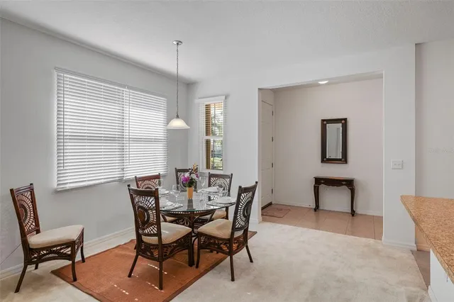a view of a dining room with furniture and window