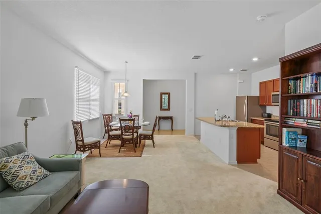 a living room with furniture and a book shelf