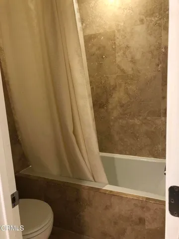 a bathroom with a bathtub and toilet