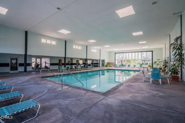 a room with lots of wooden furniture table and chairs