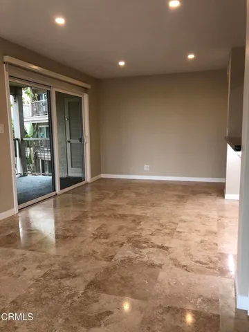 a view of a livingroom with wooden floor and a large window