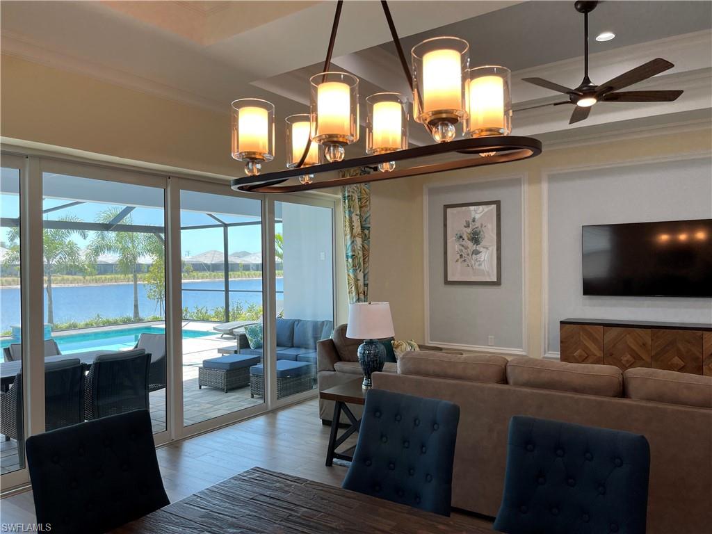 6282 Indies Avenue Naples, FL 34113 - Photo 11 of 33 a living room with furniture and a flat screen tv