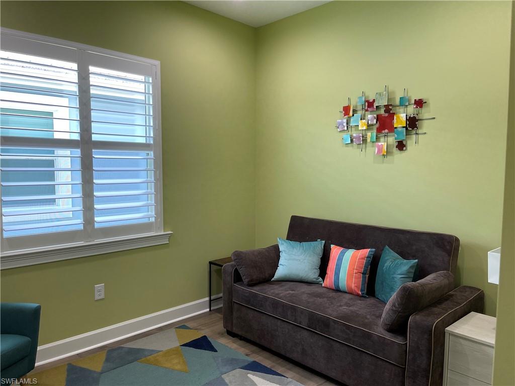 6282 Indies Avenue Naples, FL 34113 - Photo 12 of 33 a living room with a couch and a window