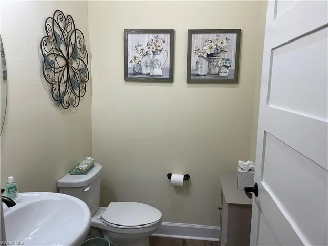 a white toilet sitting next to a bathroom sink
