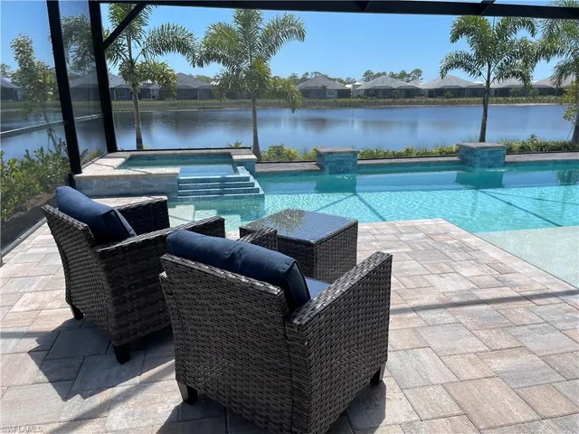 a view of a patio with lawn chairs and a table