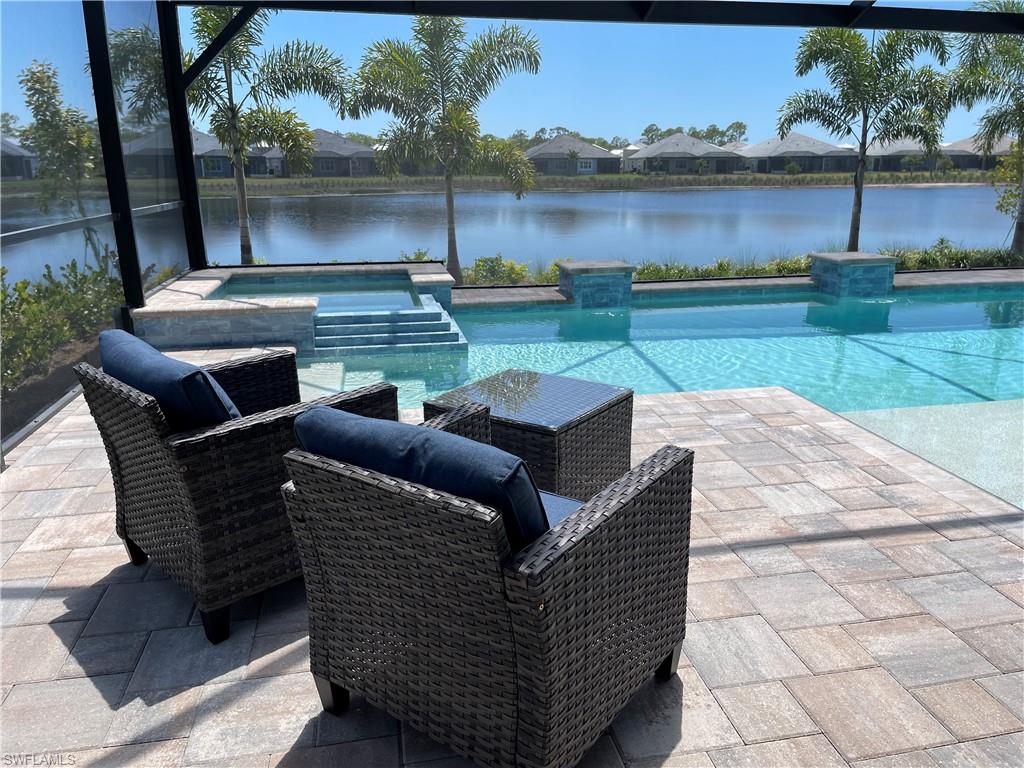 6282 Indies Avenue Naples, FL 34113 - Photo 22 of 33 a view of a patio with lawn chairs and a table