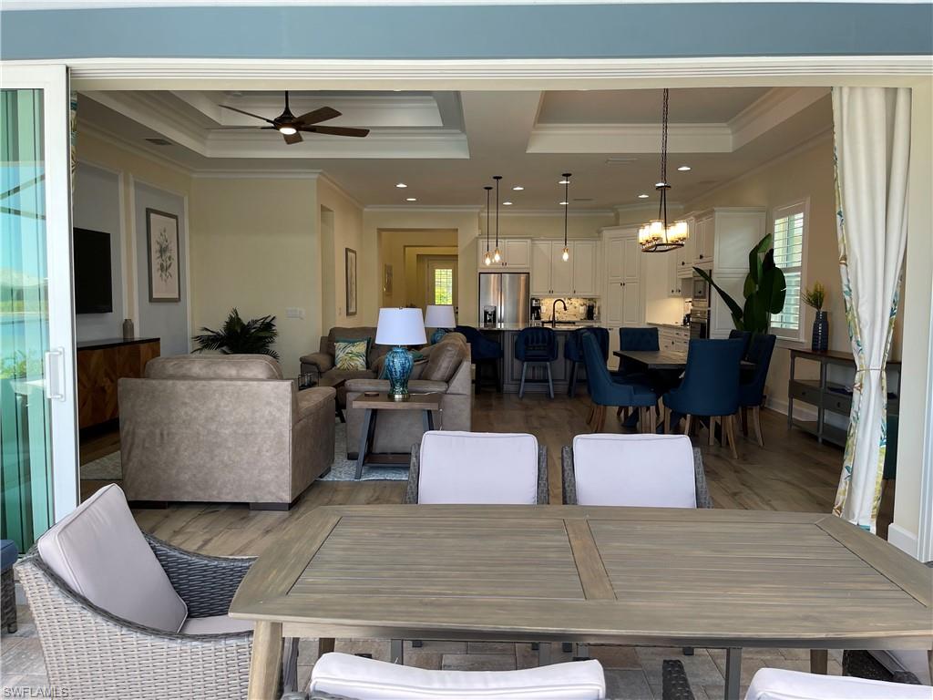 6282 Indies Avenue Naples, FL 34113 - Photo 25 of 33 a living room with furniture and a chandelier