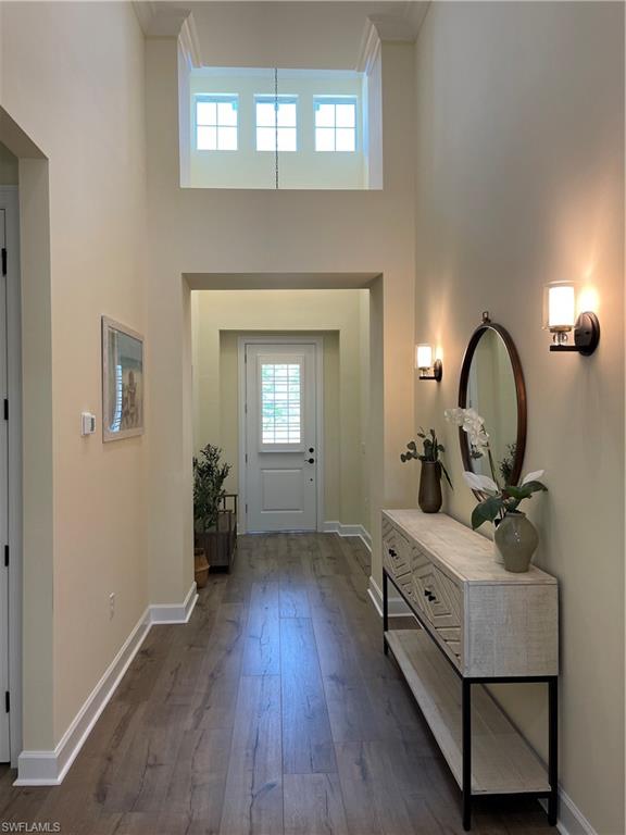 6282 Indies Avenue Naples, FL 34113 - Photo 3 of 33 a living room with a bed furniture and a fireplace