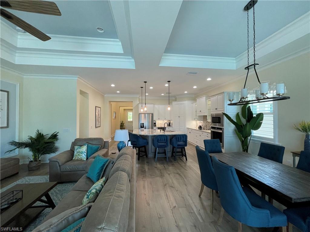 6282 Indies Avenue Naples, FL 34113 - Photo 6 of 33 a view of a dining room with furniture window and wooden floor