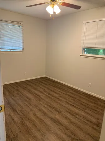 a view of a room with wooden floor and fan