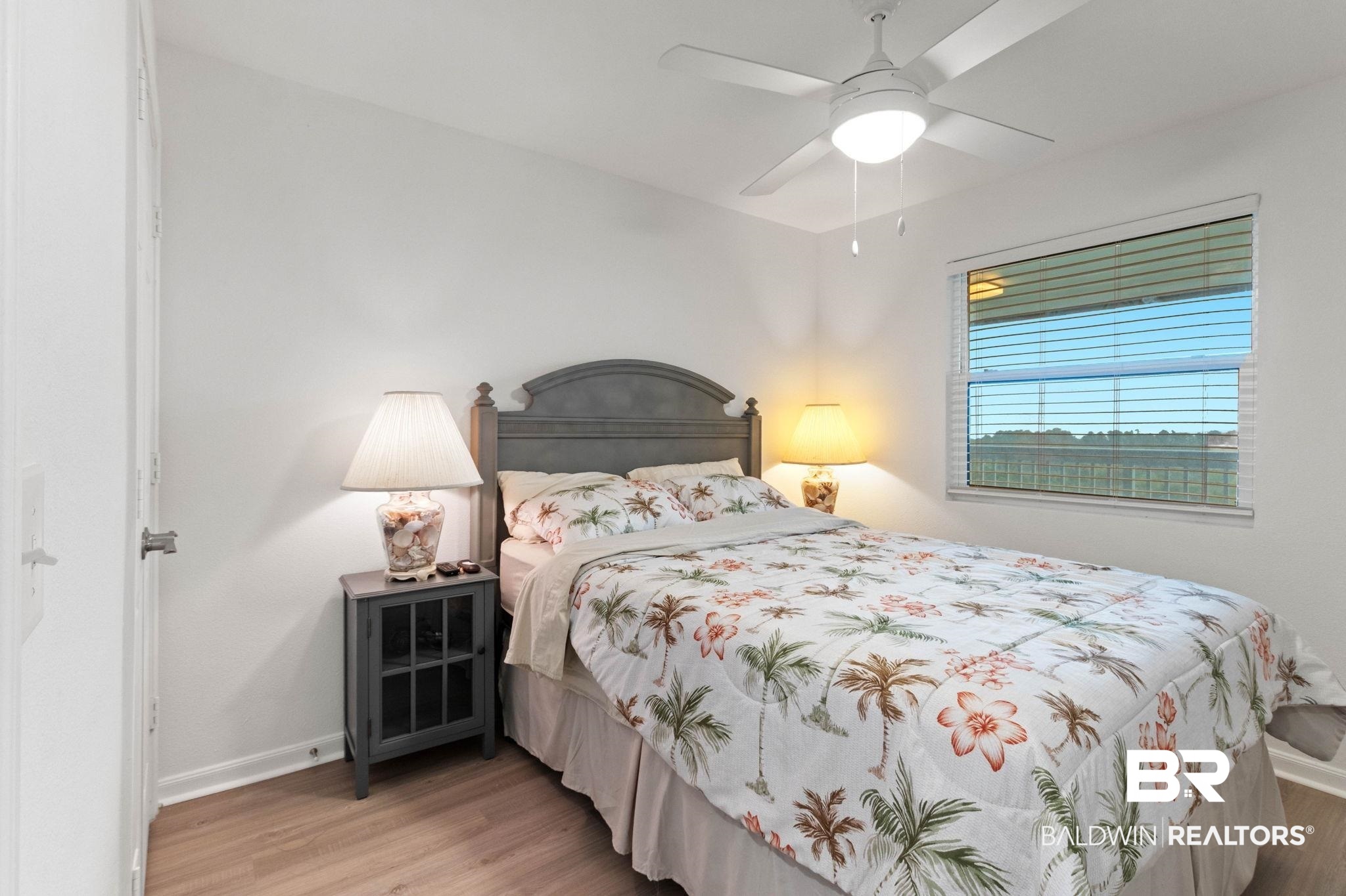 400 Plantation Road, Unit 4501 Gulf Shores, AL 36542 - Photo 13 of 30 Bedroom featuring wood-finish flooring, a ceiling fan with integrated lighting, a window with horizontal blinds, and a paneled door