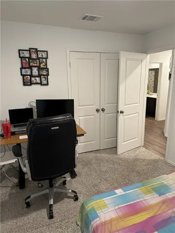 a bedroom with a bed and a desk