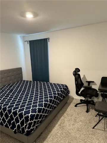 a view of a hallway to a livingroom and a livingroom with furniture