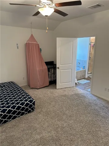 a spacious bedroom with a bed and a window