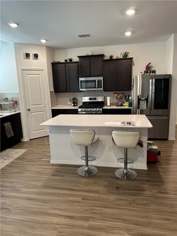 a kitchen with stainless steel appliances a refrigerator stove microwave and sink