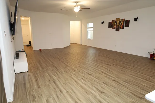 a view of a room with wooden floor