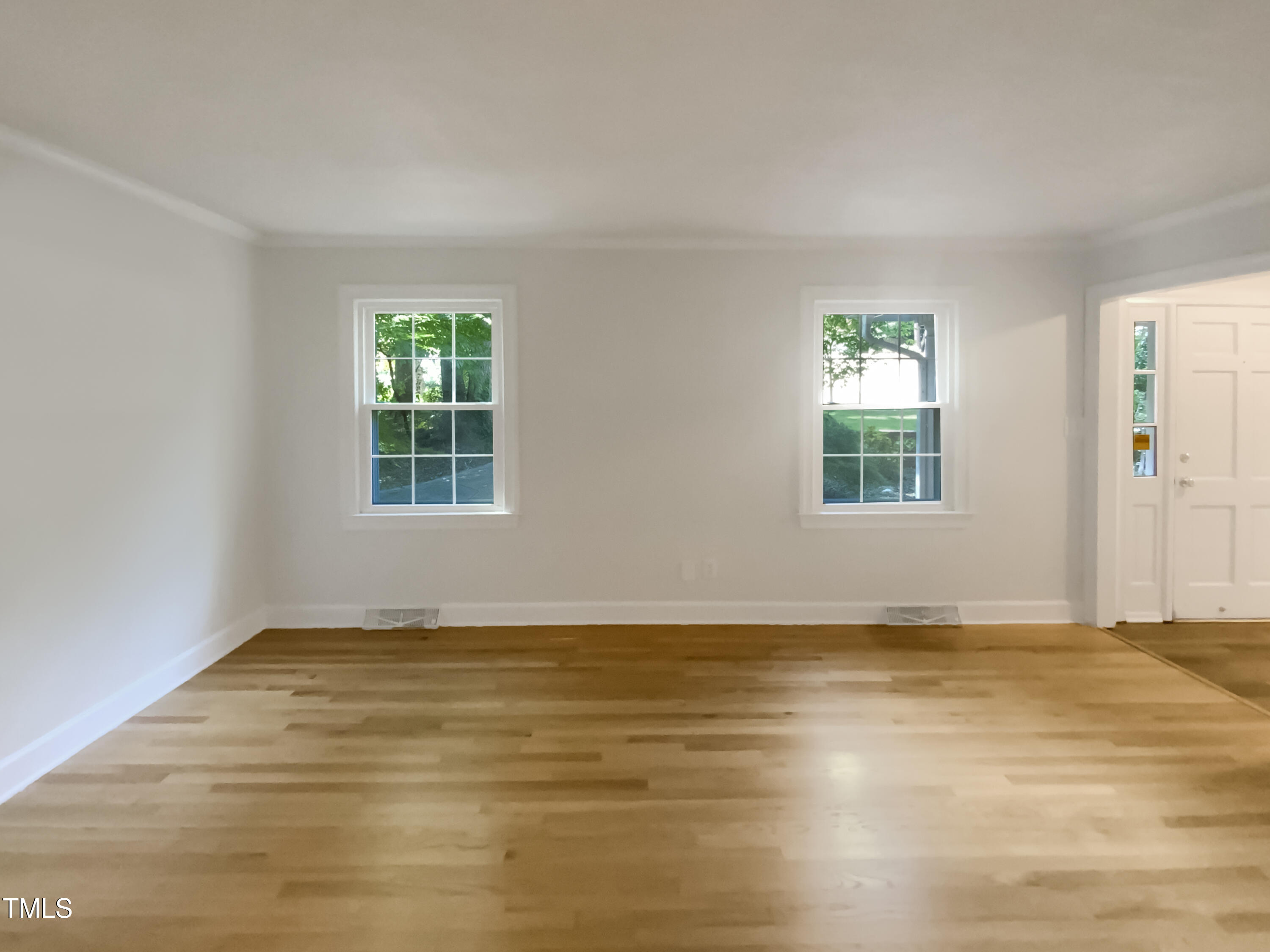 4808 Connell Drive Raleigh, NC 27612 - Photo 12 of 20 an empty room with wooden floor and windows