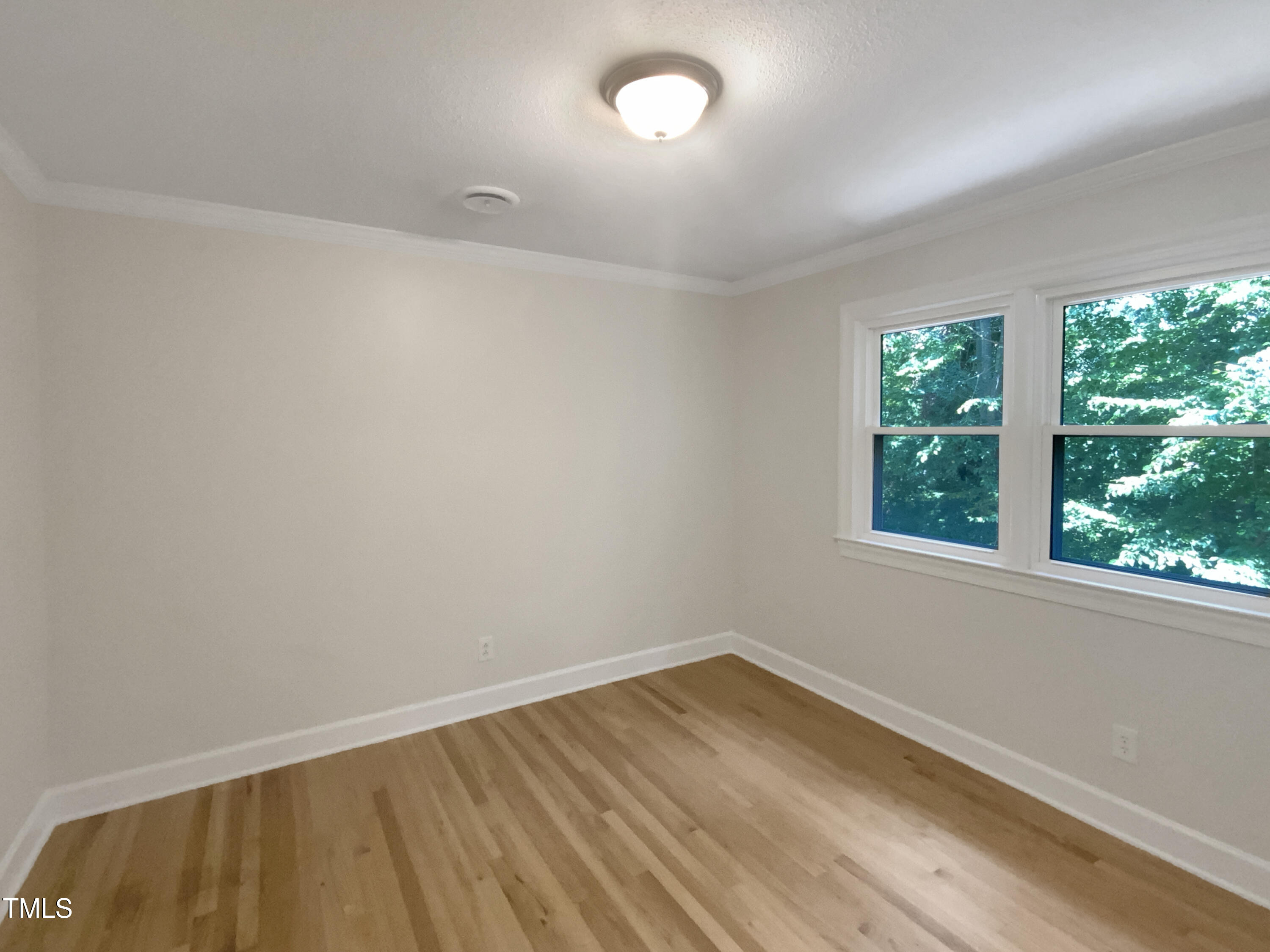 4808 Connell Drive Raleigh, NC 27612 - Photo 13 of 20 wooden floor in an empty room with a window