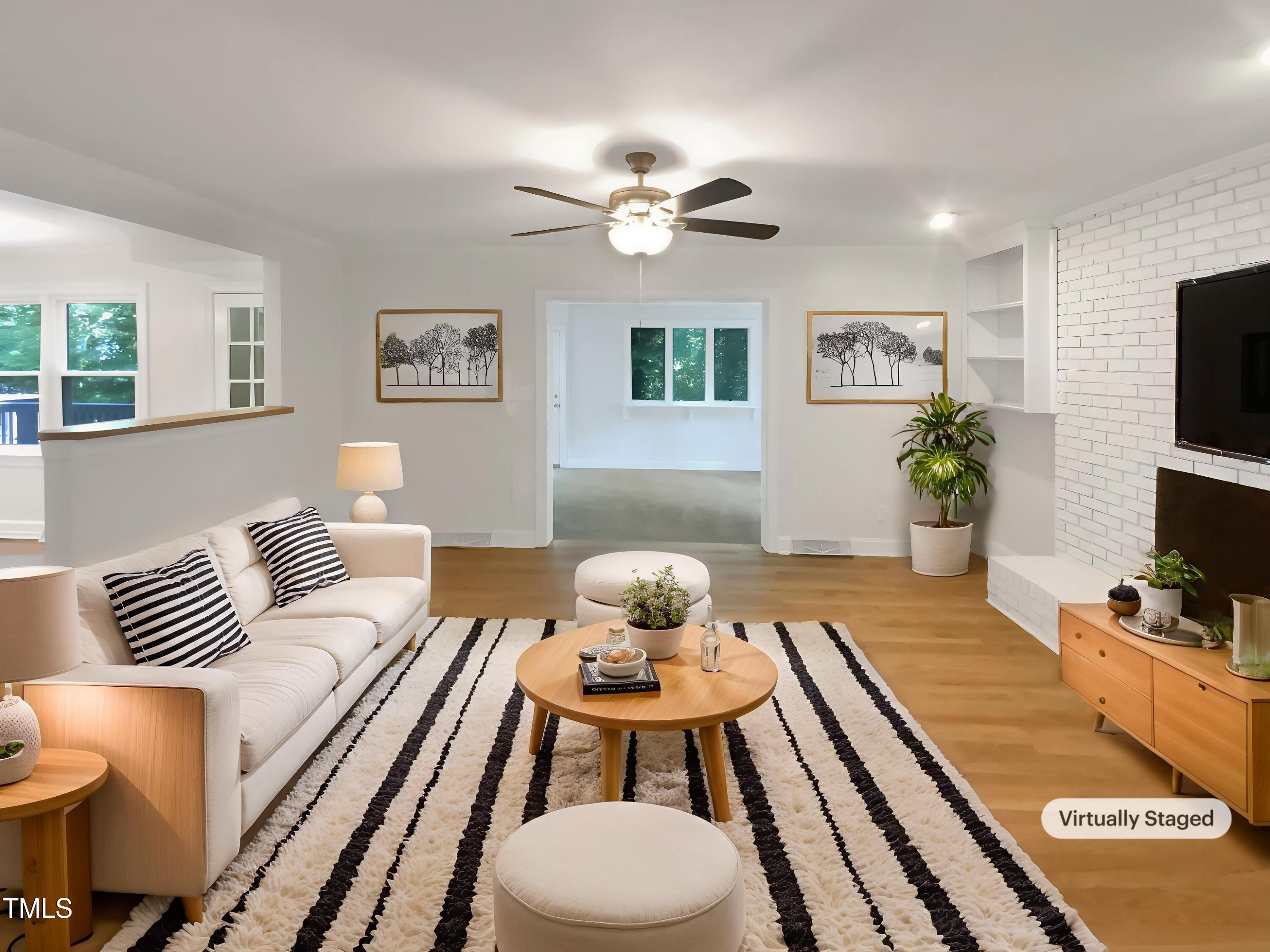 4808 Connell Drive Raleigh, NC 27612 - Photo 2 of 20 a living room with furniture and a flat screen tv