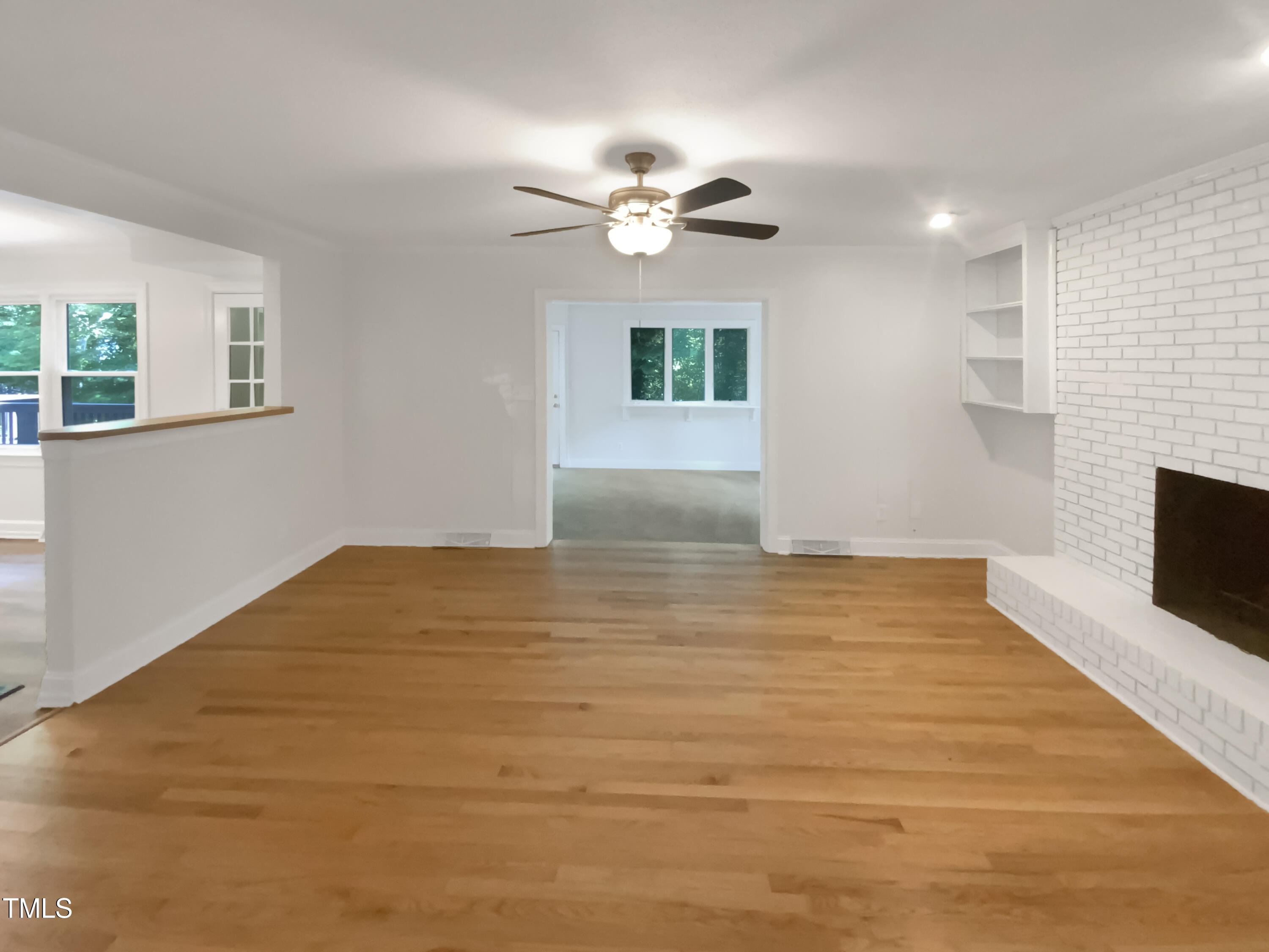 4808 Connell Drive Raleigh, NC 27612 - Photo 3 of 20 a view of empty room with wooden floor and fan