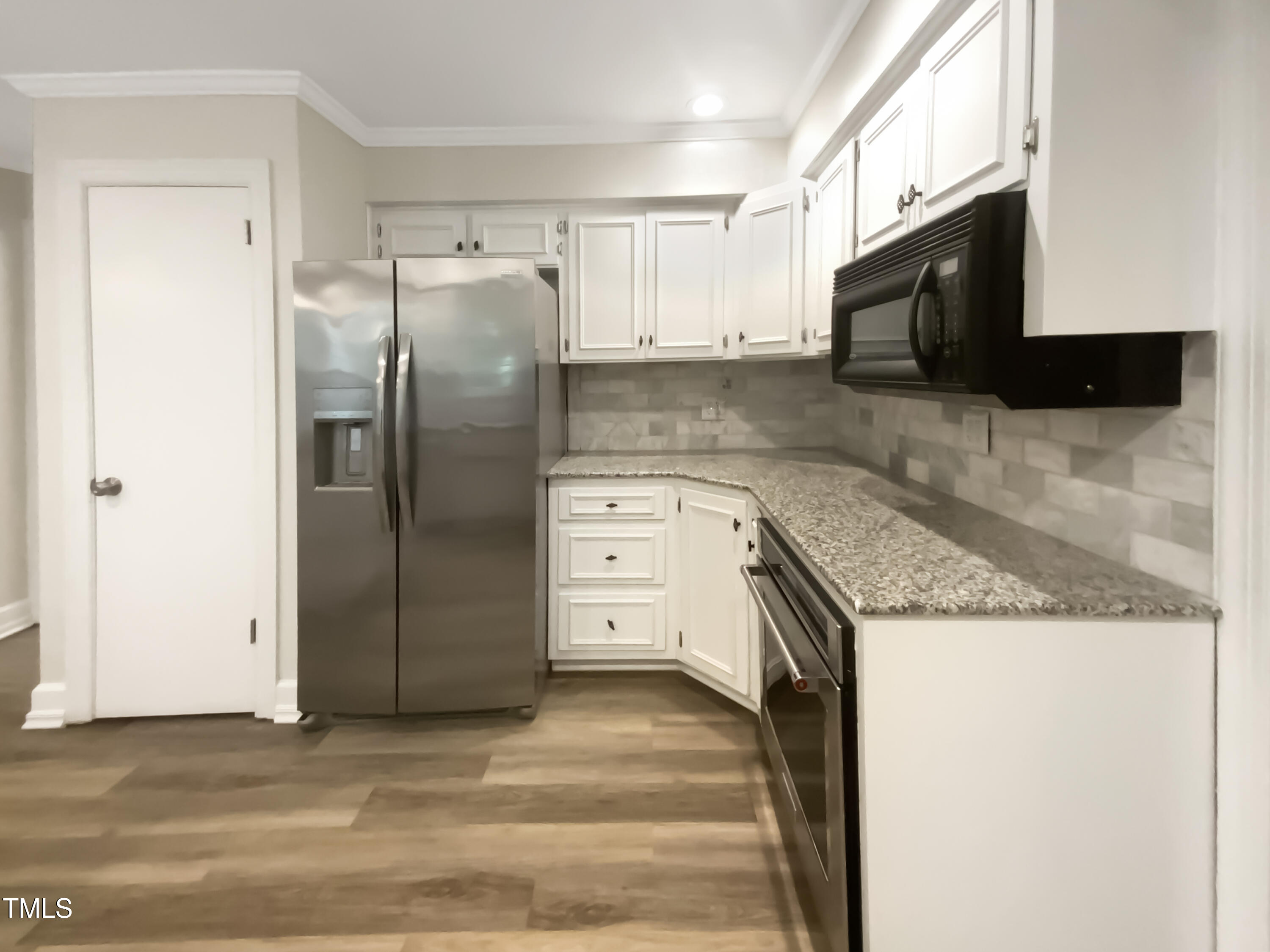 4808 Connell Drive Raleigh, NC 27612 - Photo 6 of 20 a kitchen with stainless steel appliances granite countertop a refrigerator a stove and a sink