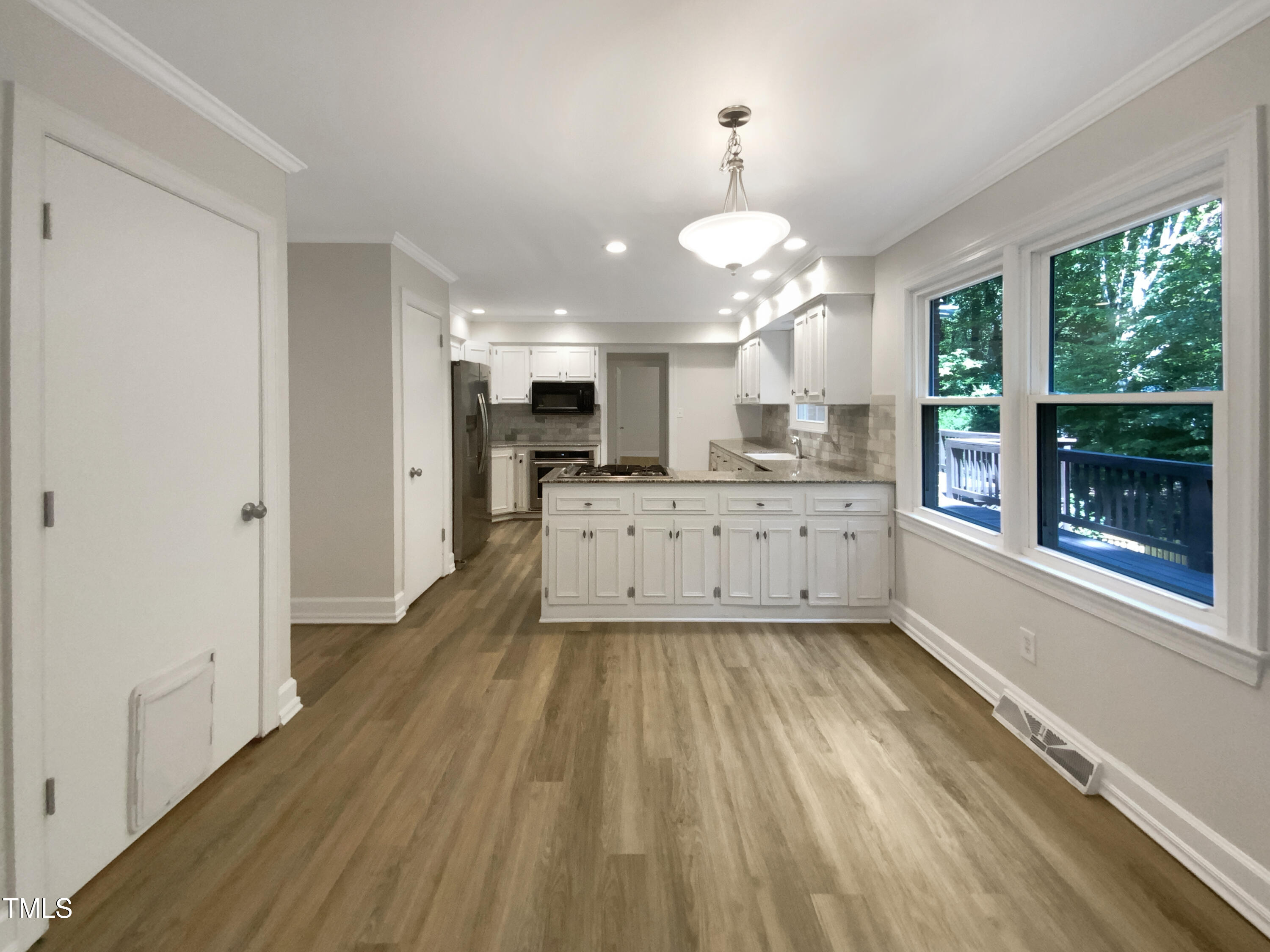 4808 Connell Drive Raleigh, NC 27612 - Photo 7 of 20 a large kitchen with a lot of counter space and a wooden floor