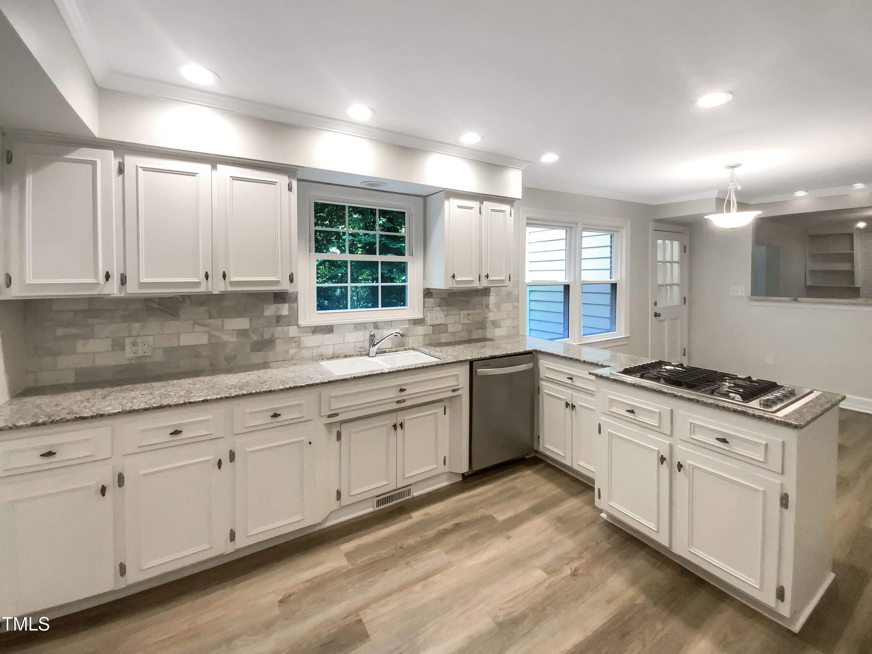4808 Connell Drive Raleigh, NC 27612 - Photo 8 of 20 a kitchen with granite countertop white cabinets and white appliances