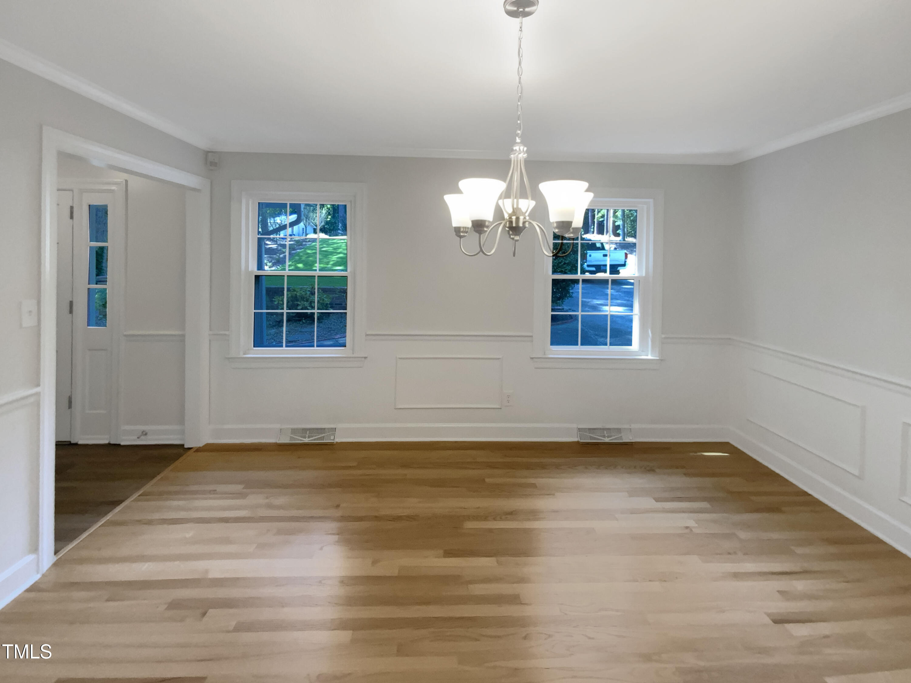 4808 Connell Drive Raleigh, NC 27612 - Photo 10 of 20 a view of an empty room with wooden floor and a window
