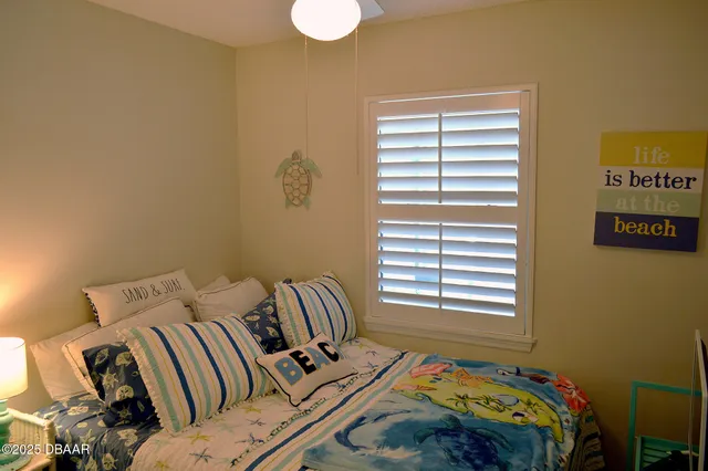 a bedroom with a bed and a window