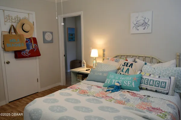 a bedroom with a bed and painting on the wall