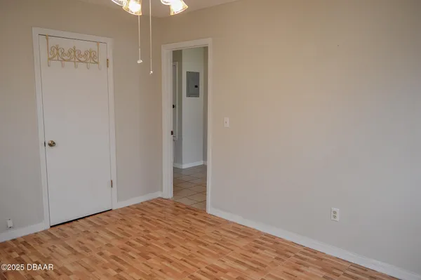 a view of empty room with wooden floor fan