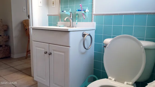 a bathroom with a sink mirror toilet and shower